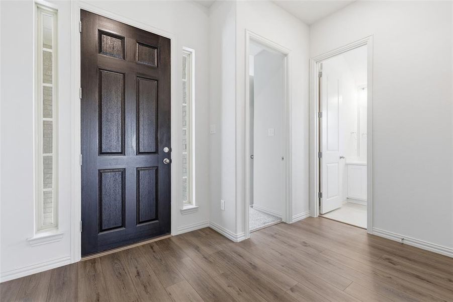 Entrance foyer with wood finished floors and baseboards