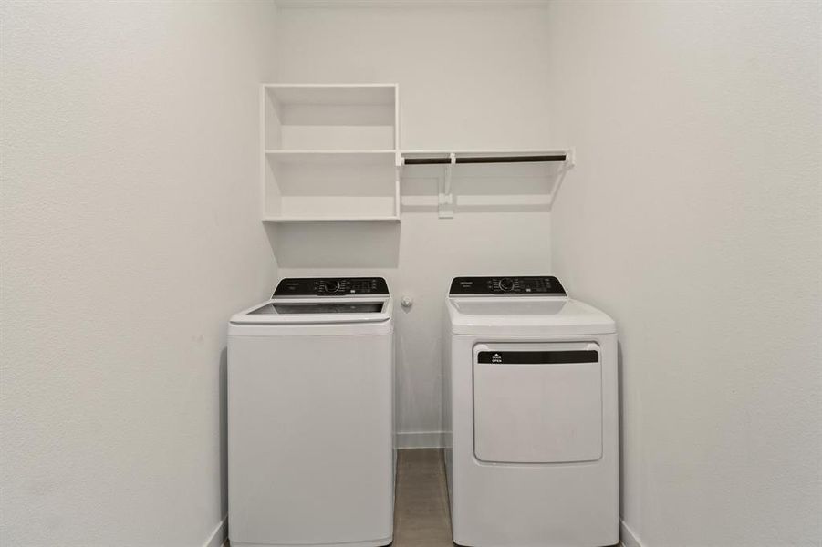 Laundry room featuring separate washer and dryer and baseboards