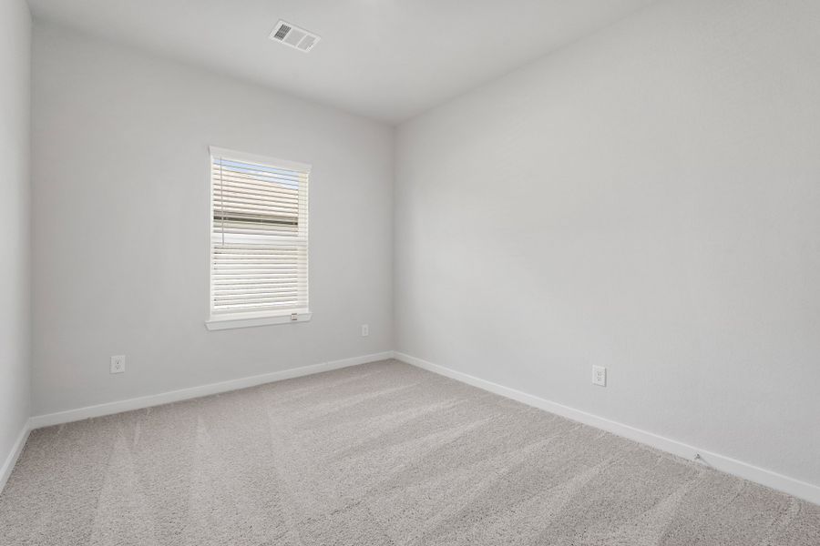 A room with a window and carpet. A room with a window and carpet.