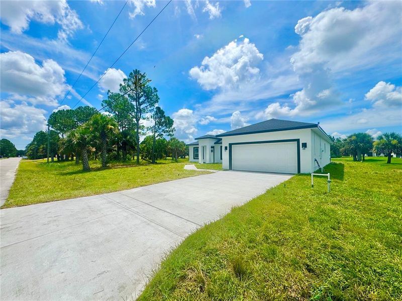 Front exterior of a new home in , Palm Bay, FL, highlighting curb appeal (Image 24).