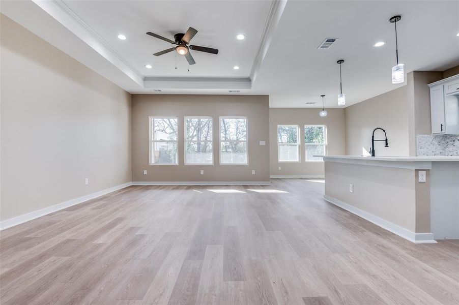 Unfurnished living room with recessed lighting, visible vents, and light wood-style flooring