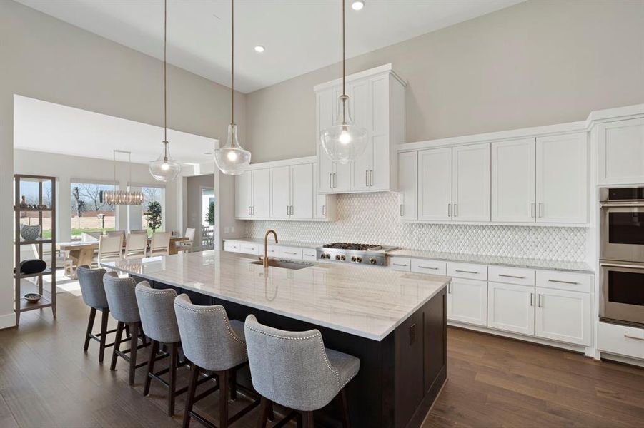 A kitchen that is open to living areas complete with a view