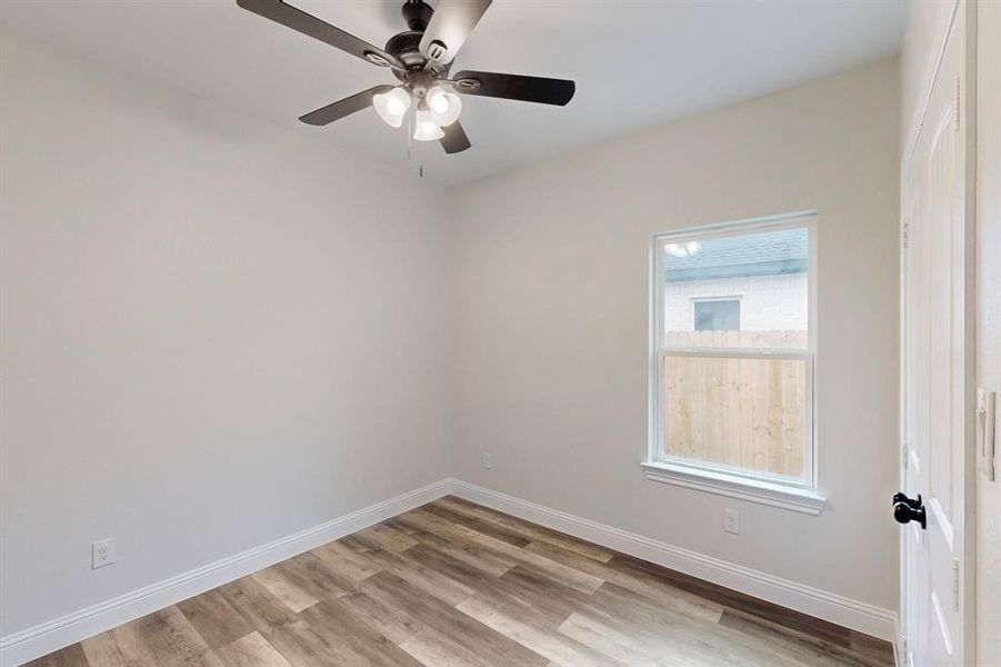 Spare room featuring ceiling fan and light wood-type flooring