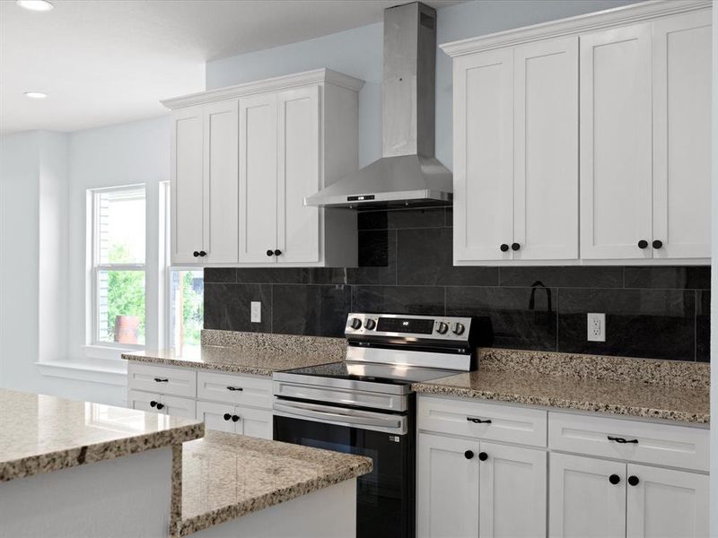 Kitchen featuring stainless steel range with electric cooktop, wall chimney exhaust hood, white cabinetry, light stone countertops, and recessed lighting