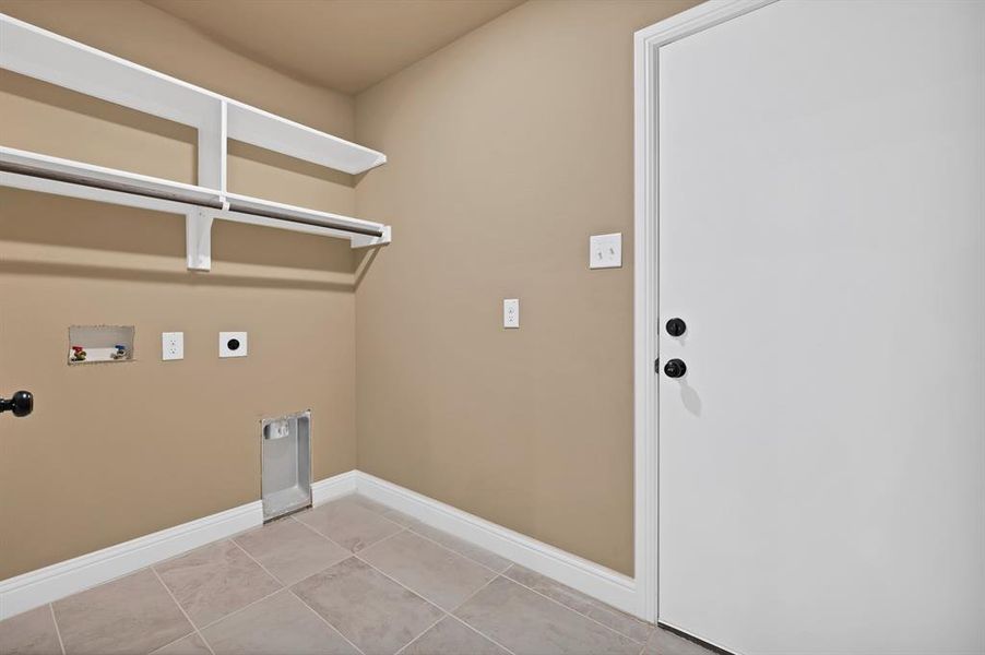 Washroom featuring laundry area, light tile patterned floors, hookup for an electric dryer, hookup for a washing machine, and baseboards Washroom featuring laundry area, light tile patterned floors, hookup for an electric dryer, hookup for a washing machine, and baseboards
