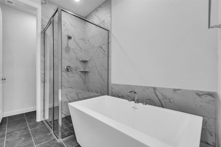Large soaking tub in the primary bathroom offers a spa-like retreat.