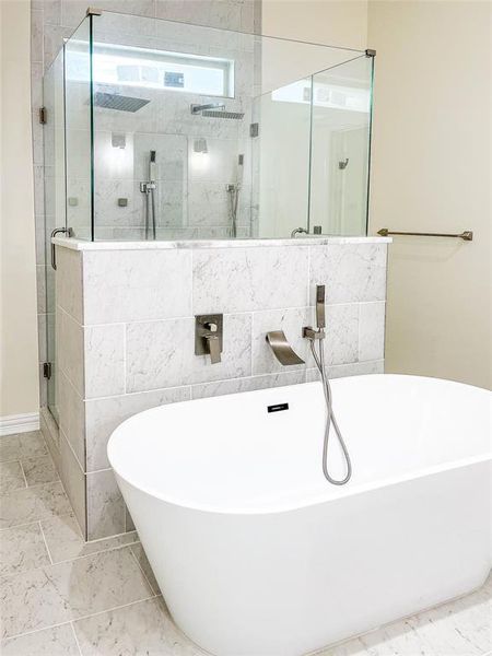 Bathroom with tile walls, tile flooring, and plus walk in shower