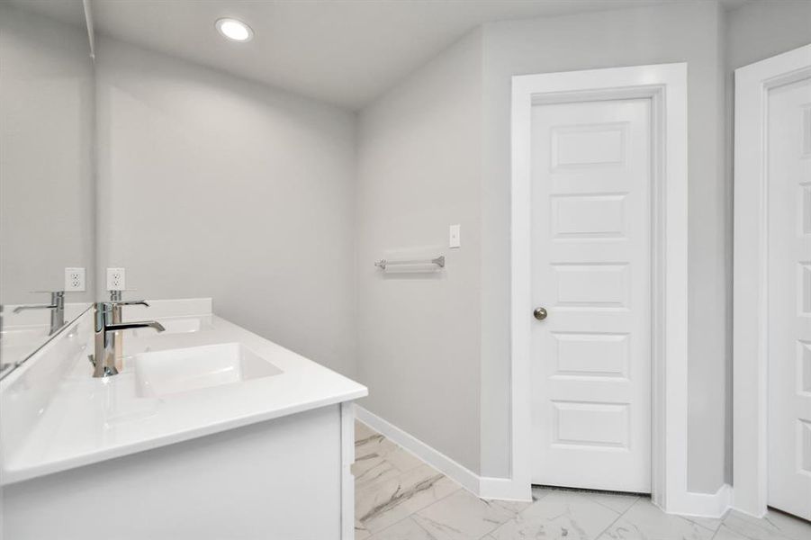 Indulge in a spa-like retreat within the confines of this primary bathroom. Sample photo of completed home with similar floor plan. As-built interior colors and selections may vary.