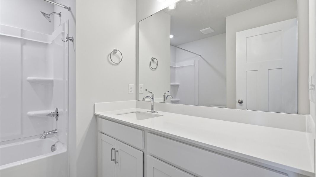Stylish guest bathroom with superior design and thoughtful storage solutions located in Simpsonville, SC