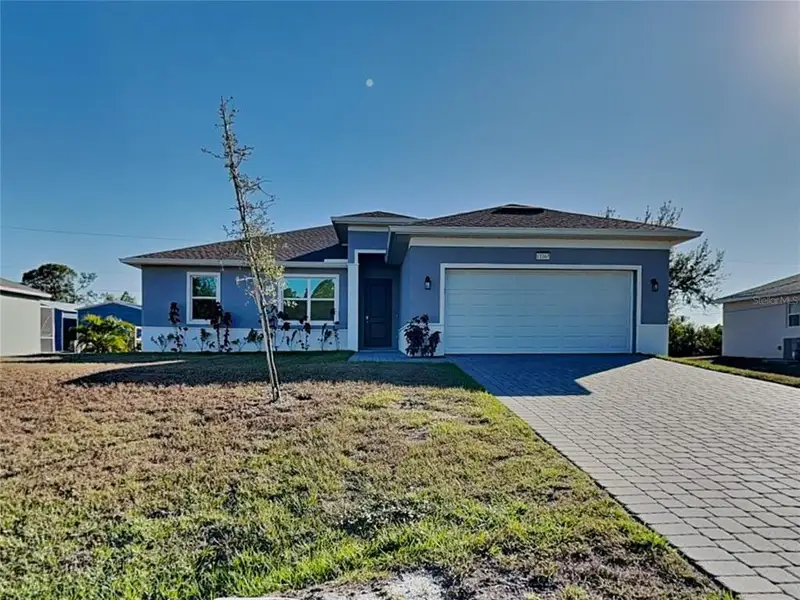 Front exterior of a new home in , Port Charlotte, FL, highlighting curb appeal (Image 1). Front exterior of a new home in , Port Charlotte, FL, highlighting curb appeal (Image 1).
