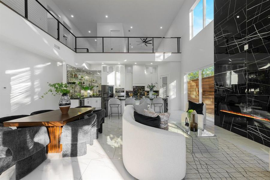 Open living room with 22 ft tile fireplace and lots of natural light. Open living room with 22 ft tile fireplace and lots of natural light.