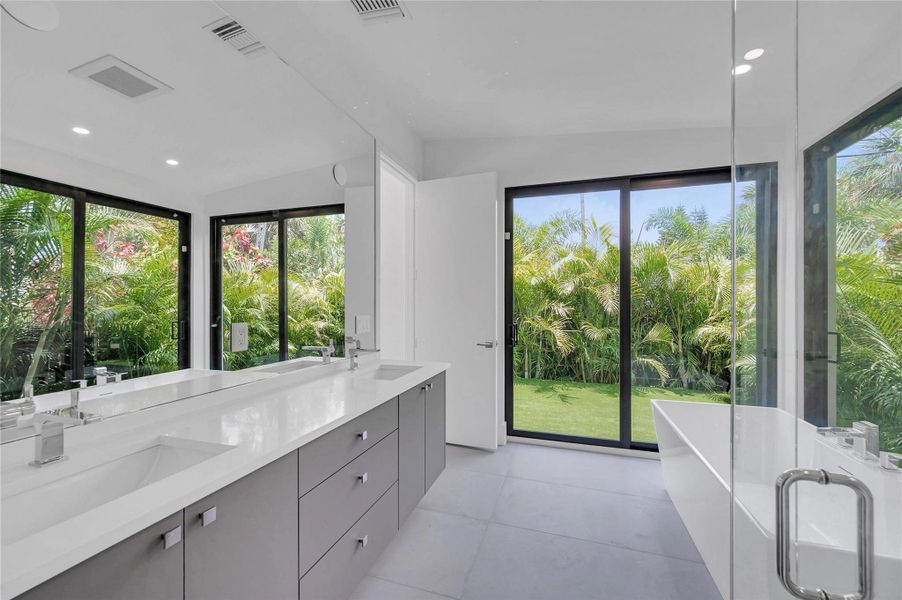 The primary bath has glass walls