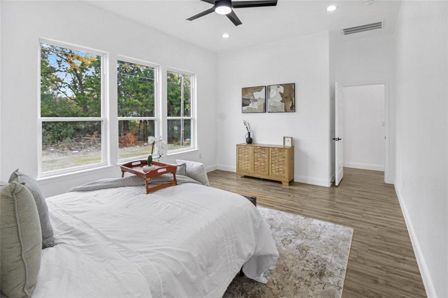 Bedroom with wood finished floors, recessed lighting, and ceiling fan Bedroom with wood finished floors, recessed lighting, and ceiling fan