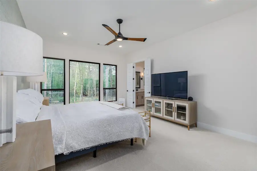 Luxury primary suite, comfortably decorated with high grade Berber carpet in an organic cream.  Huge picture window to enjoy the tranquil vistas and double doors open to the oasis spa ensuite bath and primary walk-in closet.