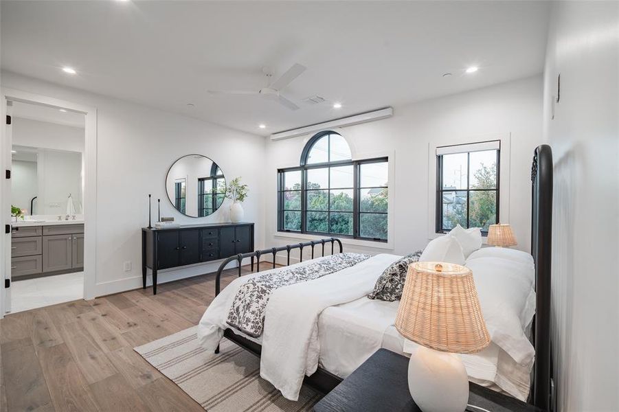 Living room with built in shelves, sink, a fireplace, and light hardwood / wood-style flooring