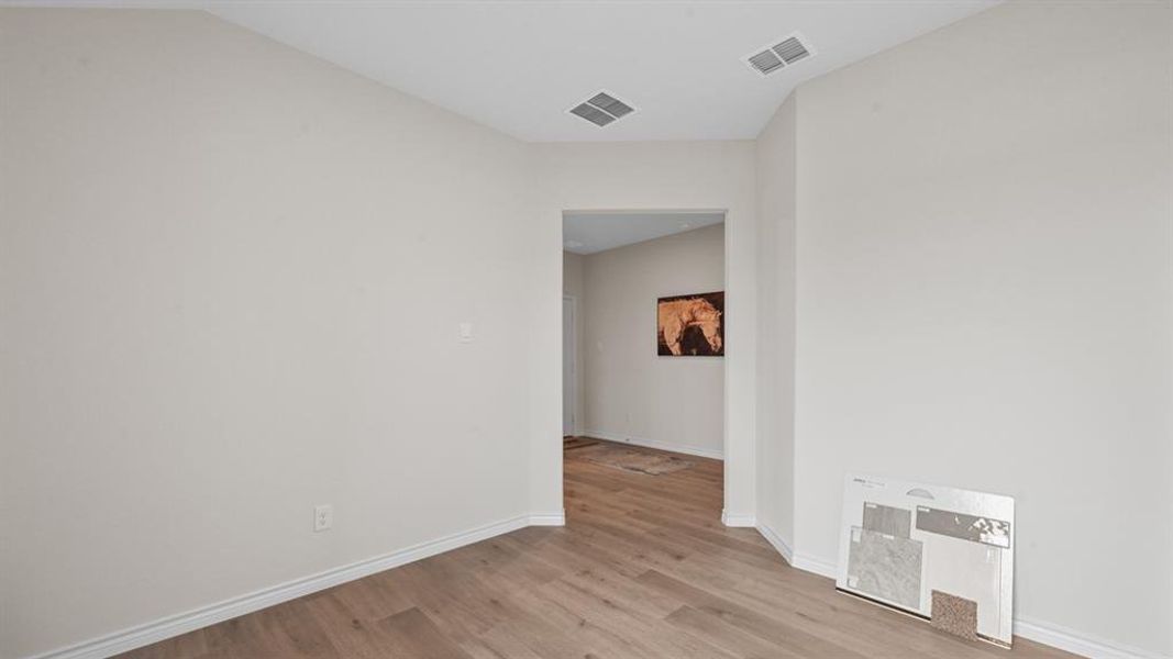 Spare room with light wood finished floors and baseboards Spare room with light wood finished floors and baseboards