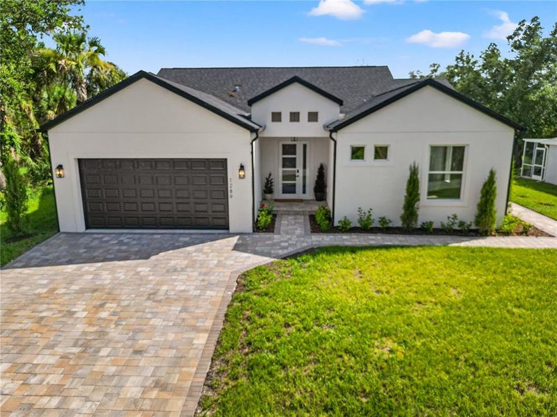 Front exterior of a new home in , North Port, FL, highlighting curb appeal (Image 29). Front exterior of a new home in , North Port, FL, highlighting curb appeal (Image 29).