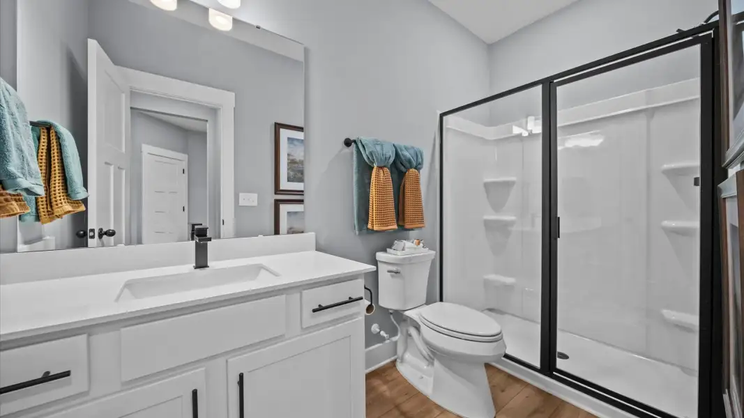 Spacious and modern primary bathroom with walk-in shower Spacious and modern primary bathroom with walk-in shower