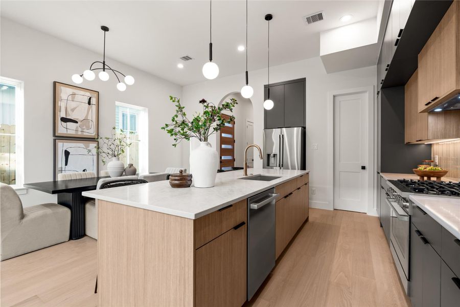 Kitchen opens to the dining area - large enough for a full table (as staged). Large island also seats four comfortably. Kitchen opens to the dining area - large enough for a full table (as staged). Large island also seats four comfortably.