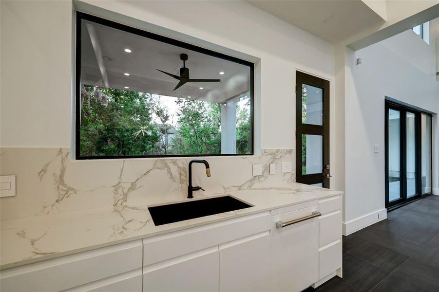 Oversized sink, with DEKTON luxury porcelain draped all around this kitchen.