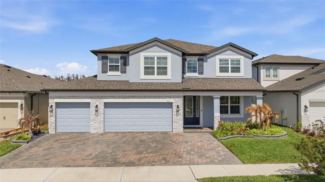 Front exterior of a new home in Whispering Oaks Preserve, Wesley Chapel, FL, highlighting curb appeal (Image 1). Front exterior of a new home in Whispering Oaks Preserve, Wesley Chapel, FL, highlighting curb appeal (Image 1).