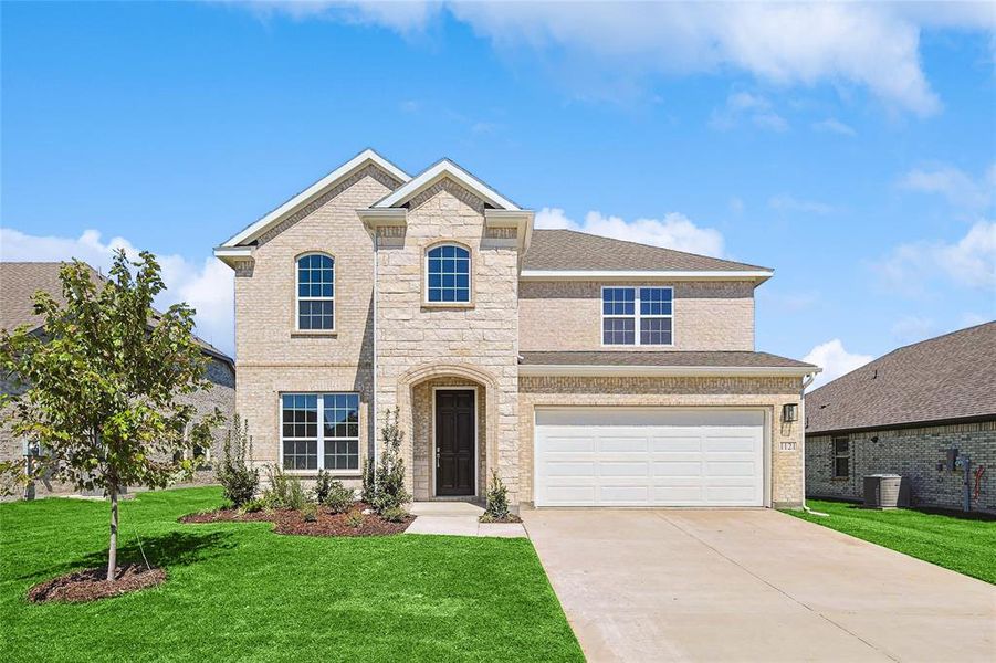 View of front of home featuring a front yard, a garage, and central AC