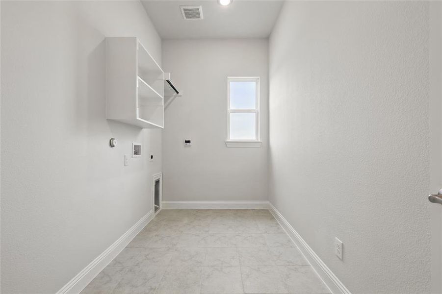 Laundry area with hookup for a washing machine, gas dryer hookup, visible vents, electric dryer hookup, and laundry area