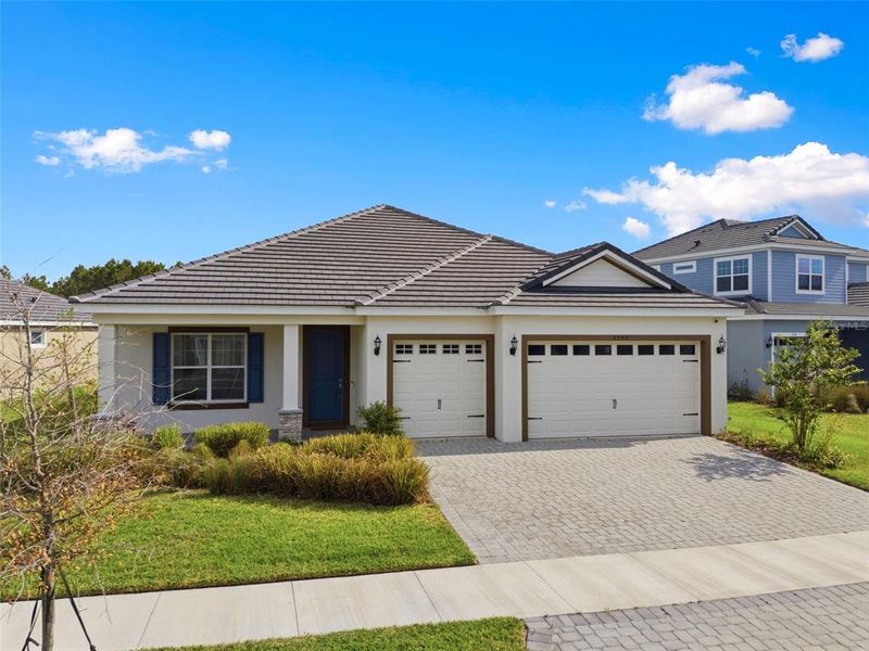 Front exterior of a new home in Tamarack at Two Rivers, Zephyrhills, FL, highlighting curb appeal (Image 31).