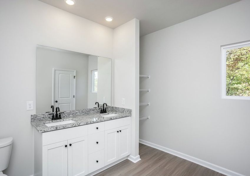 The master bathroom features dual-vanity sinks.