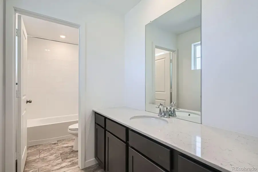 Furnished interior in a model home at Newlin Crossing: The Pioneer Collection in Parker (Image 7).