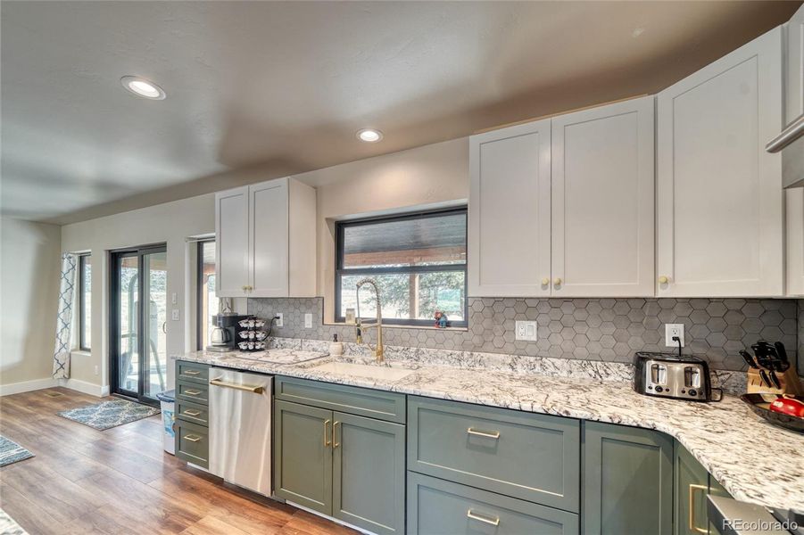 Beautiful green lower cabinets and fresh white uppers