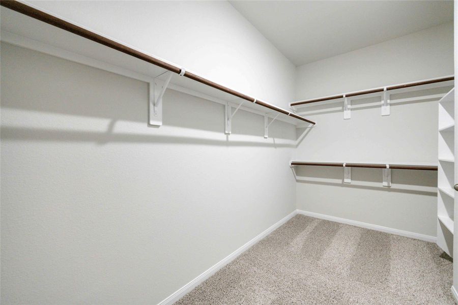 The primary closet has built-in shelving and clothes hanging rods, helping to make your closet organization dreams come true!