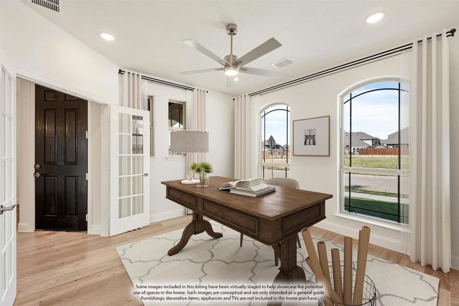Home office with wood desk, ceiling fan, arched windows, and hardwood floors Home office with wood desk, ceiling fan, arched windows, and hardwood floors