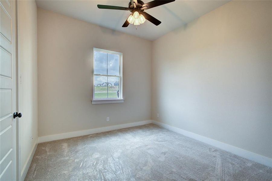 Unfurnished room featuring carpet flooring and ceiling fan