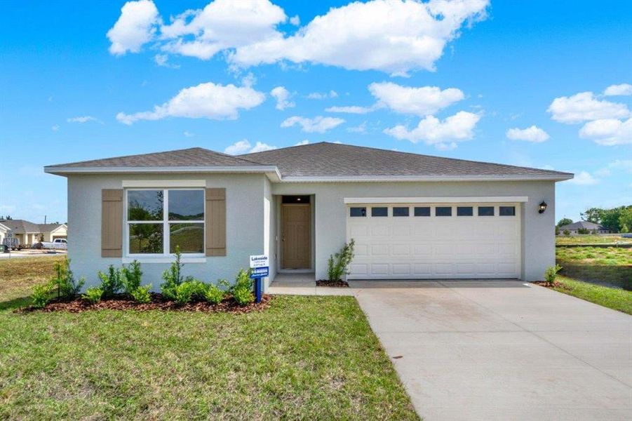 Front exterior of a new home in Bradbury Creek, Haines City, FL, highlighting curb appeal (Image 1).