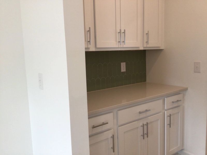 Butler’s Pantry featuring the AW Collection® Coastal - Glass-front storage with ocean tones.