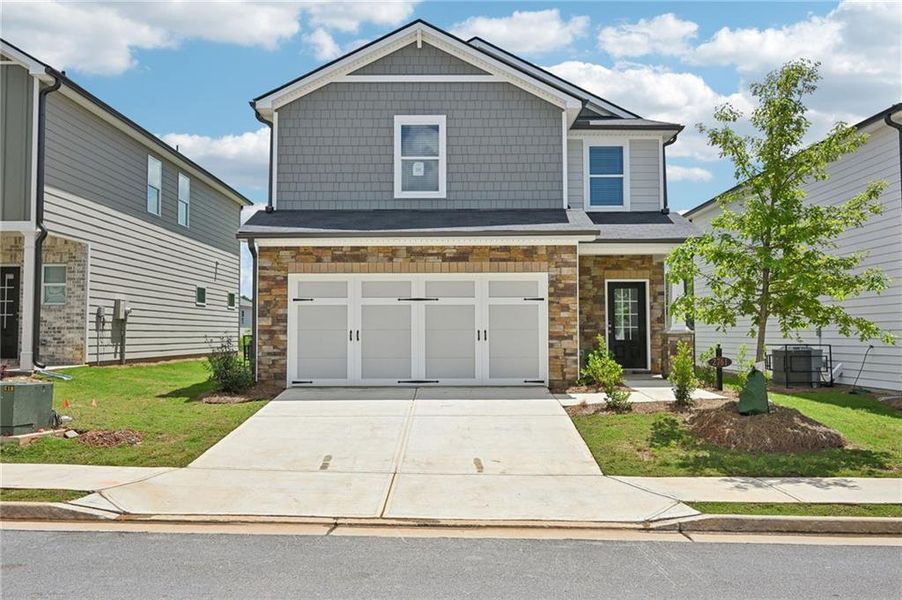 Front exterior of a new home in Hawthorne Station, College Park, GA, highlighting curb appeal (Image 22). Front exterior of a new home in Hawthorne Station, College Park, GA, highlighting curb appeal (Image 22).