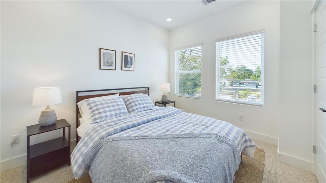 Secondary bedroom - located on the second floor. Vinyl windows with retractable panels allow in tons of natural light.