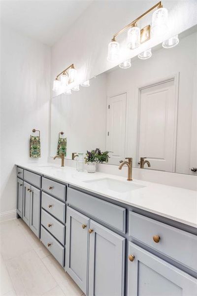 Bathroom with double vanity and light tile patterned floors Bathroom with double vanity and light tile patterned floors