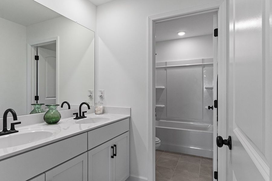 A bathroom with a sink and a shower.