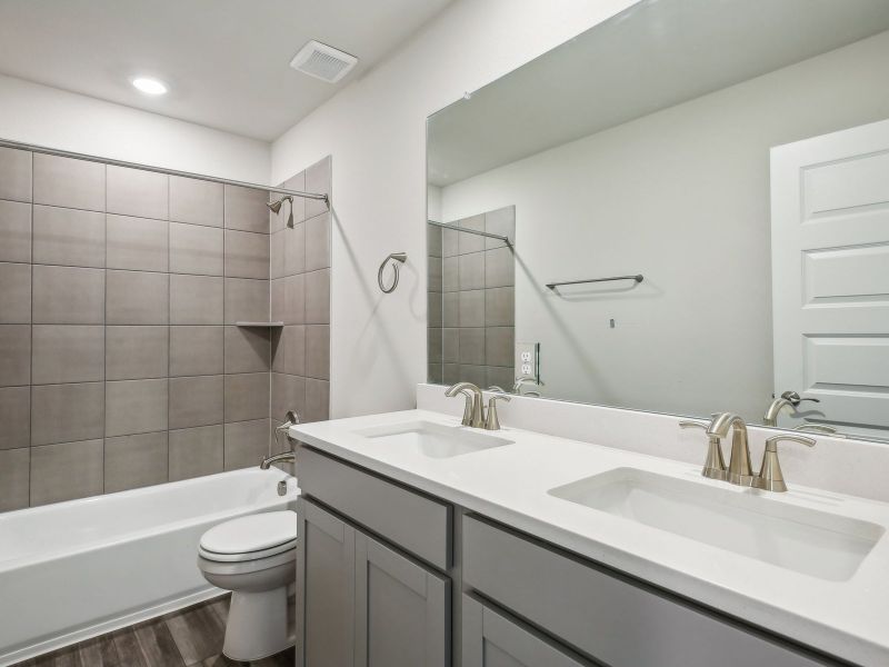 This upstairs full guest bathroom makes getting ready easier for everyone.