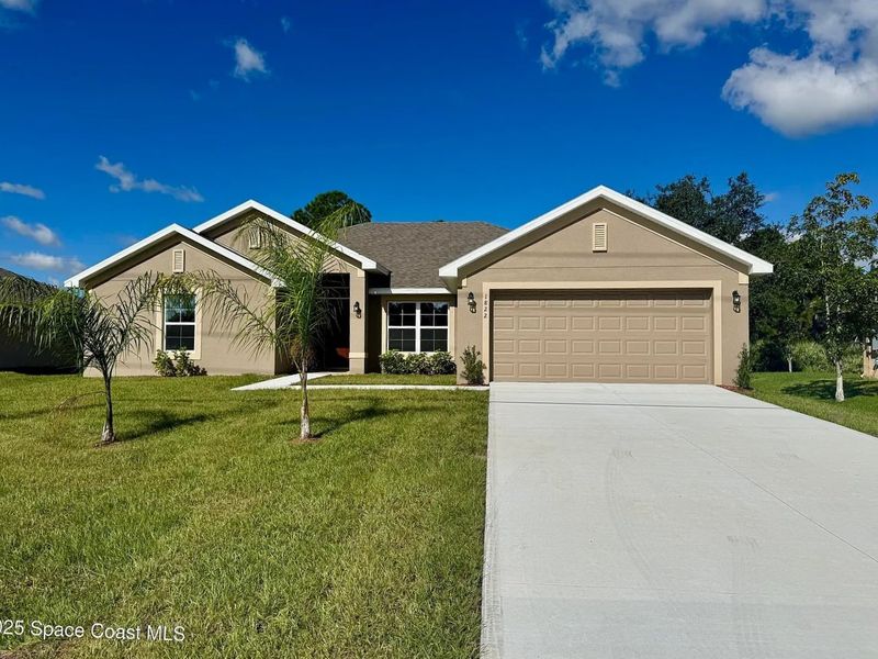 Front exterior of a new home in Palm Bay, Palm Bay, FL, highlighting curb appeal (Image 1).