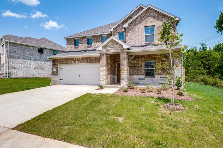 Craftsman-style home with a garage, covered porch, and a front lawn