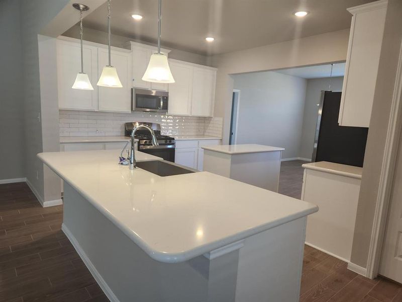 Lovely kitchen with quartz countertops and maple cabinets