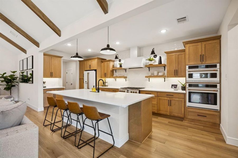 No detail overlooked—designer upgrades include full-height tile backsplash, stunning exposed beams, and Cafe appliances. No detail overlooked—designer upgrades include full-height tile backsplash, stunning exposed beams, and Cafe appliances.