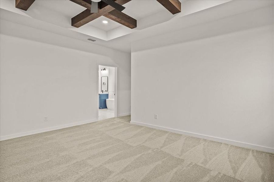 Carpeted spare room with coffered ceiling and beam ceiling