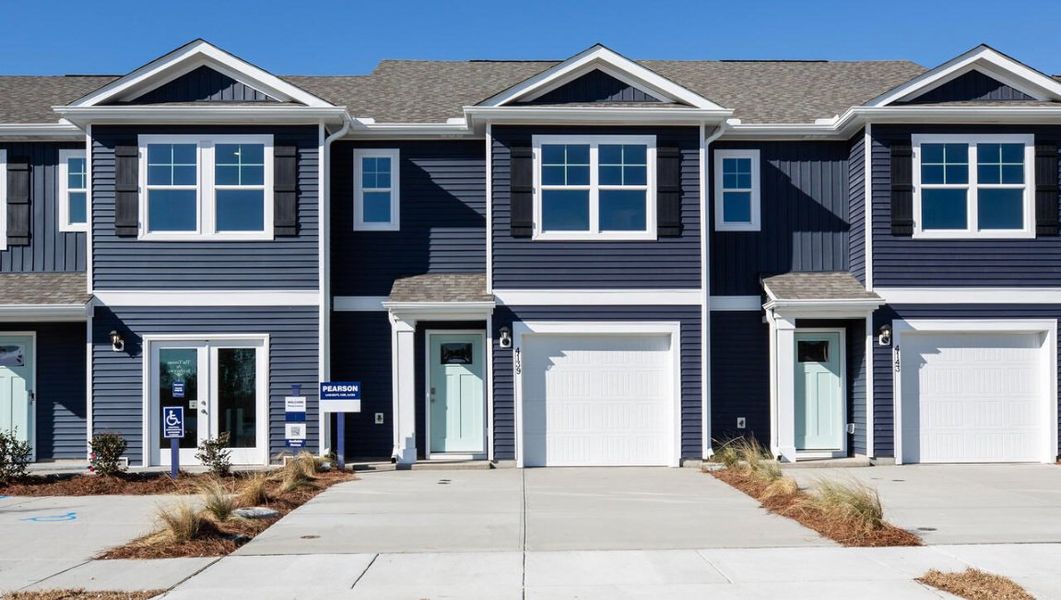 Front exterior of a new home in Waterside Townhomes, Surf City, NC, highlighting curb appeal (Image 1).