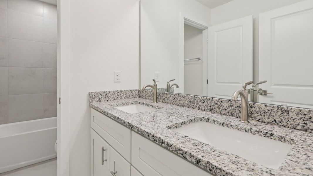 Secondary Bathroom with Dual Sink Vanity in the Naples Floor Plan by DRB Homes Secondary Bathroom with Dual Sink Vanity in the Naples Floor Plan by DRB Homes