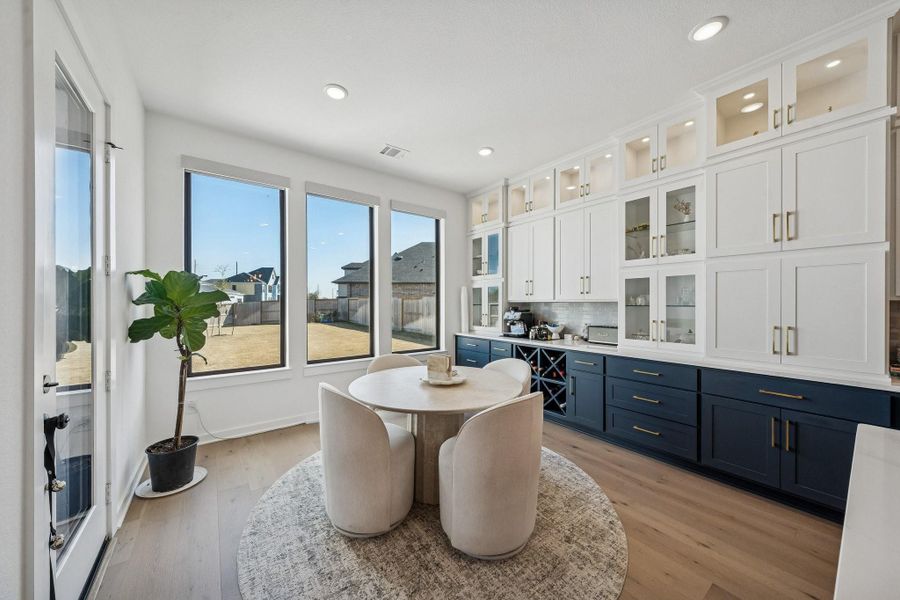 This darling breakfast nook is perfect for everyday dining. Note the upgraded built-in hutch extending the amount of storage. Utilize the glass door cabinets to display your favorite china and decor.