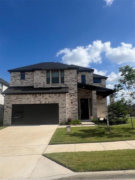 Contemporary two-story residence featuring light-toned brick and dark accents Contemporary two-story residence featuring light-toned brick and dark accents